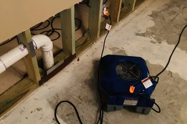 Water spreading across a room from a leaking appliance supply hose