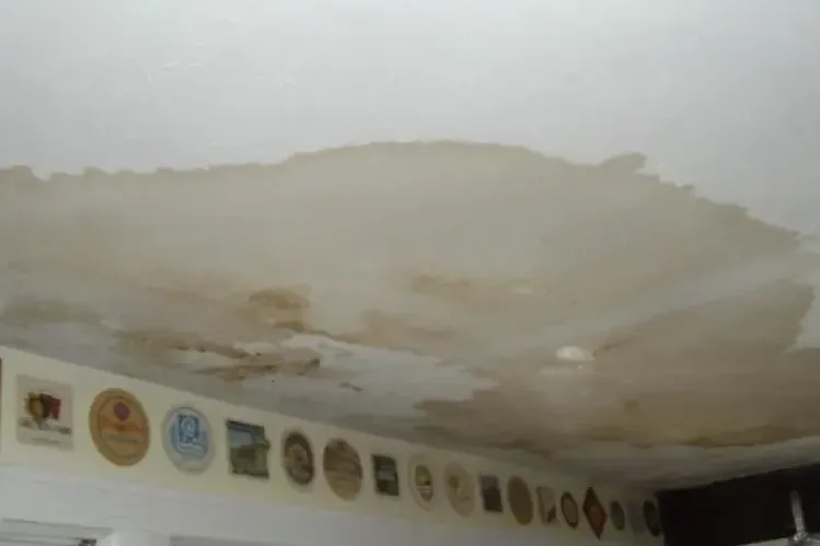 Large water stain spreading across a kitchen ceiling
